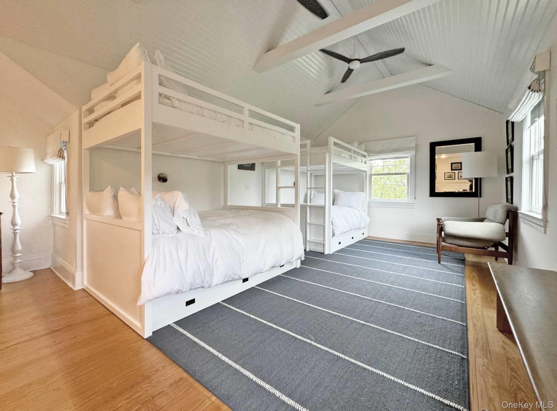 4 Sandacres Road Quogue, NY 11959 - Photo 26 of 32 a view of a bedroom with wooden floor and windows
