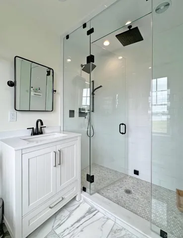 a bathroom with a double vanity sink a mirror and shower