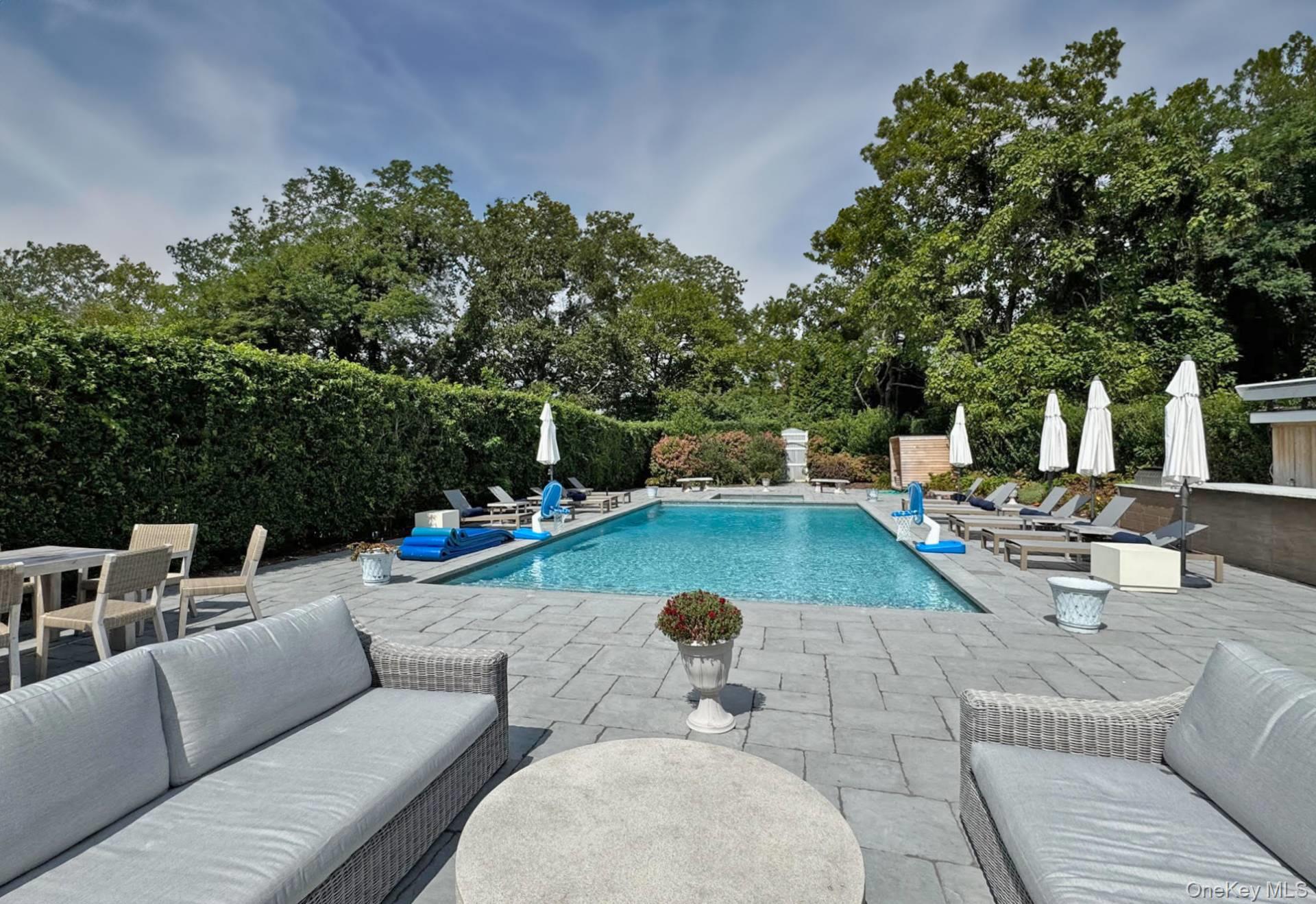 4 Sandacres Road Quogue, NY 11959 - Photo 10 of 32 a view of a patio with couches and a fire pit