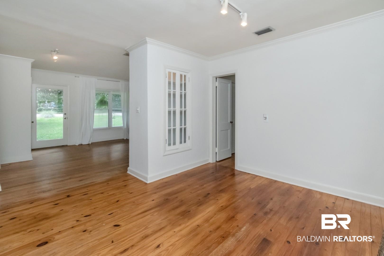 1906 Old Shell Road Mobile, AL 36607 - Photo 15 of 26 Unfurnished room featuring track lighting, crown molding, and hardwood / wood-style floors