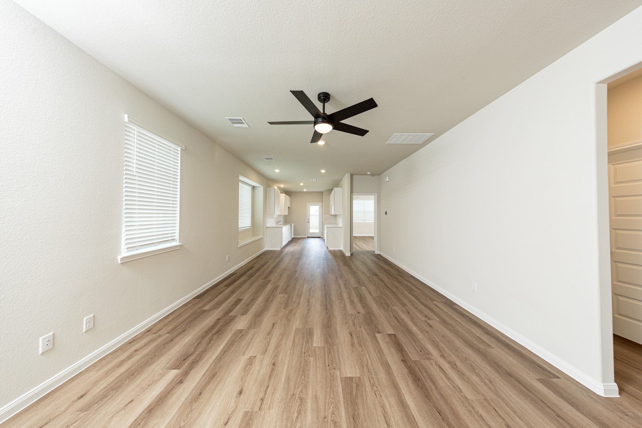 13651 Kit Run Splendora, TX 77372 - Photo 4 of 27 a view of empty room with wooden floor and fan