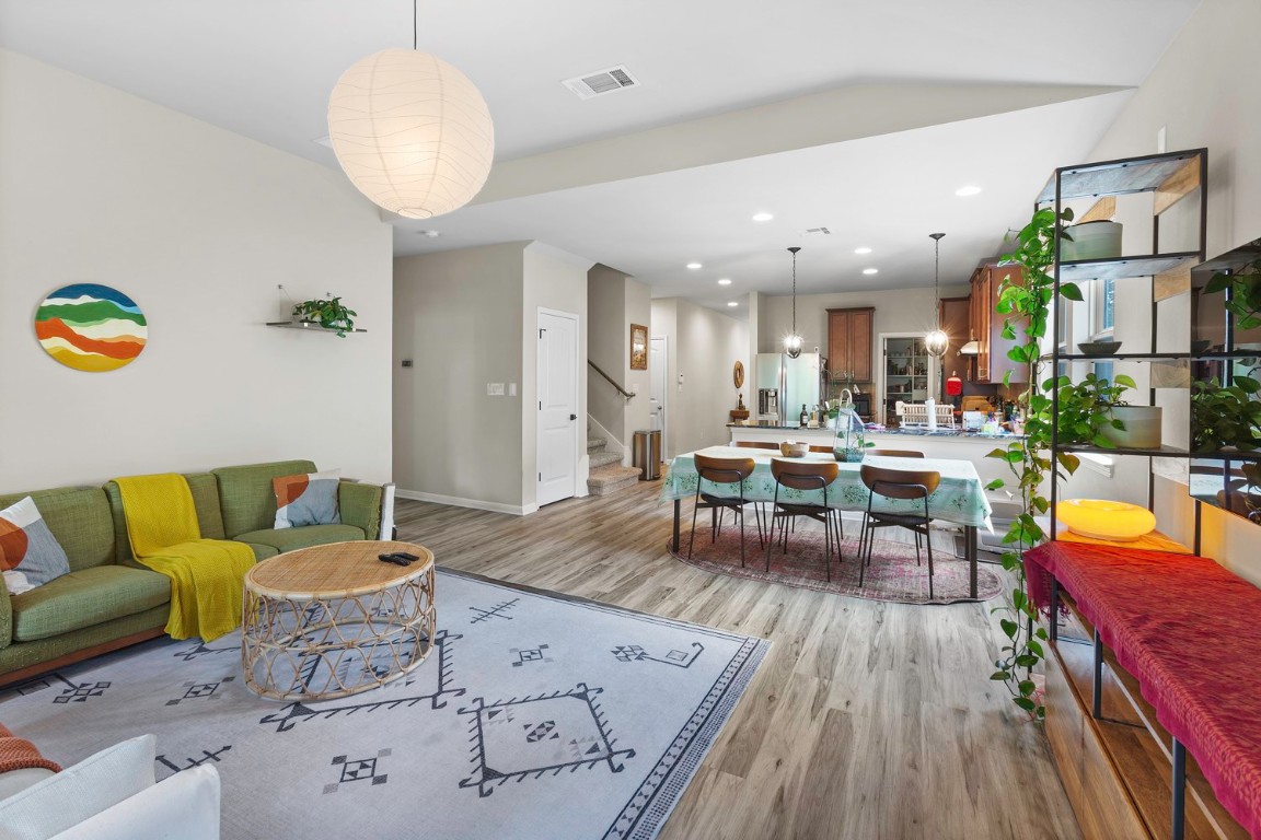 a living room with lots of furniture and kitchen view