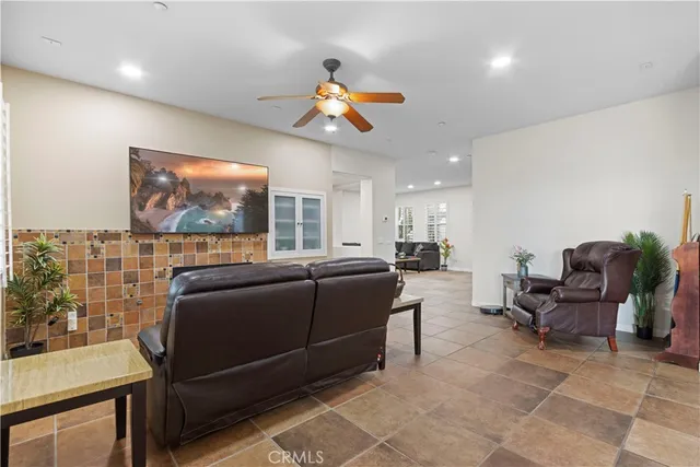 a living room with furniture a rug and a flat screen tv