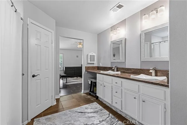 a spacious bathroom with a granite countertop sink a mirror and a