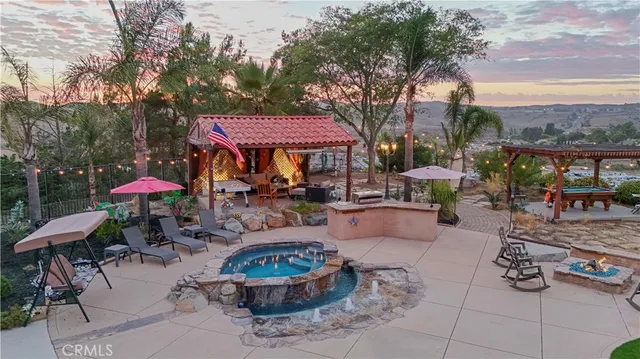 a patio with a table and chairs under an umbrella