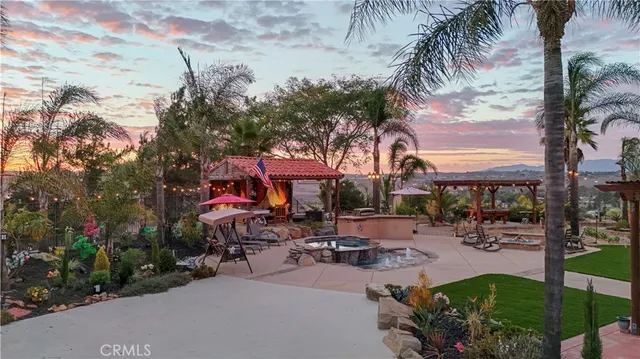 a view of a patio with a table and chairs under an umbrella