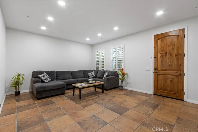 a living room with furniture a refrigerator and a dining table