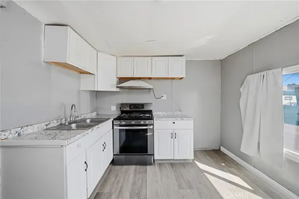 a kitchen with a sink stove and refrigerator