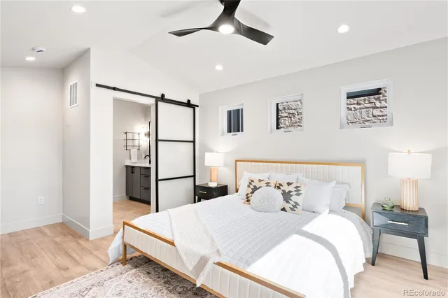 a bedroom with a bed and a refrigerator