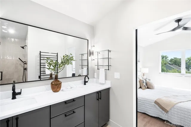 a en suite bathroom with a double vanity sink and a large mirror