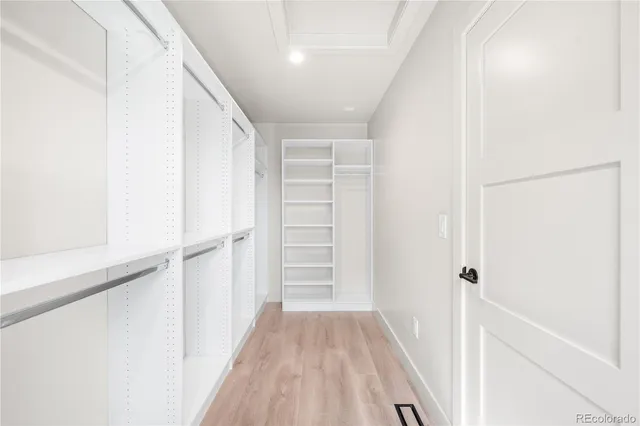 a view of a hallway with wooden floor and entryway