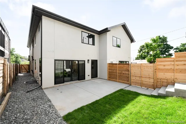 a view of a house with wooden fence