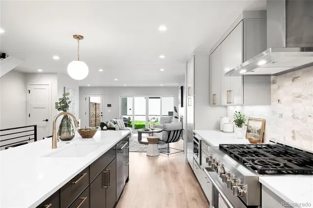 a kitchen with counter top space a sink stove and cabinets