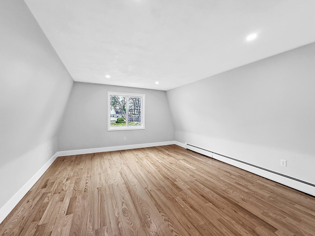 21 Burlington Road Billerica, MA 01821 - Photo 12 of 42 an empty room with wooden floor and windows