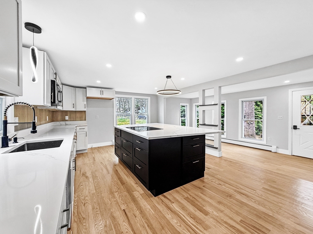 21 Burlington Road Billerica, MA 01821 - Photo 16 of 42 a kitchen with wooden floors and cabinets