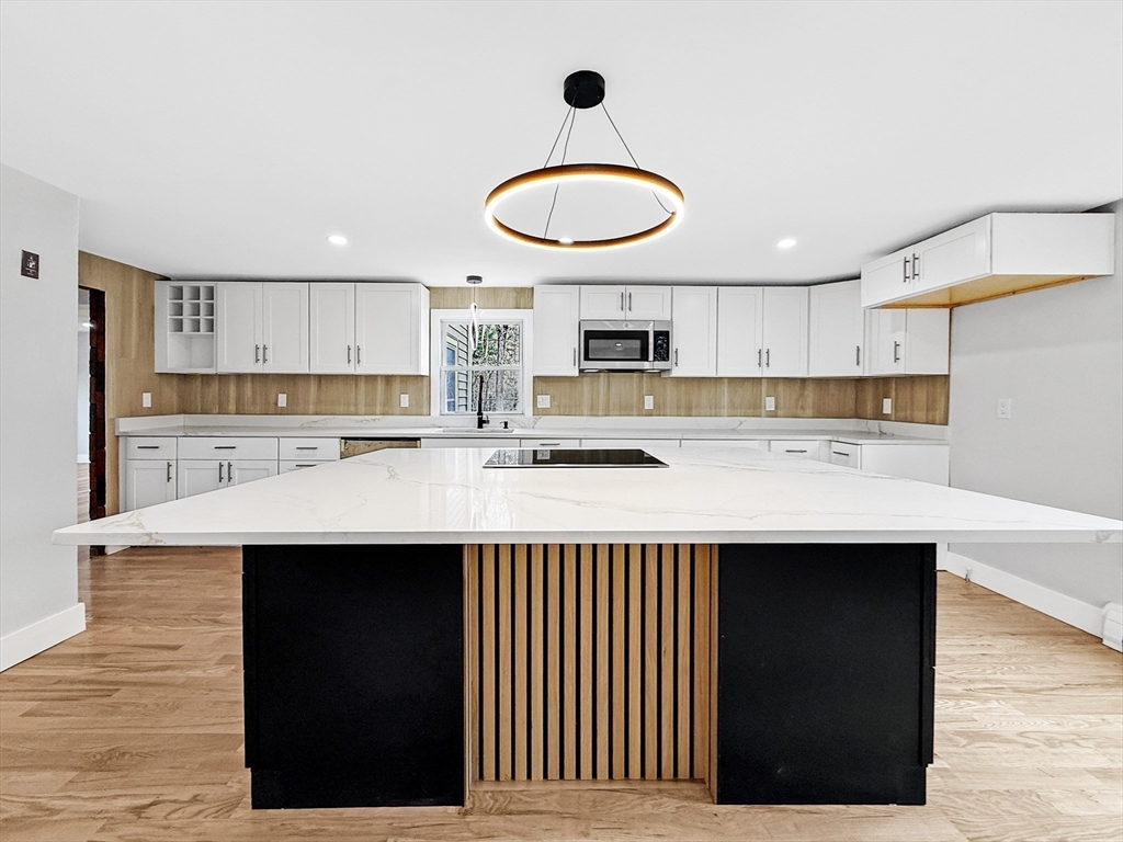 21 Burlington Road Billerica, MA 01821 - Photo 18 of 42 a kitchen with kitchen island granite countertop a sink cabinets and stainless steel appliances