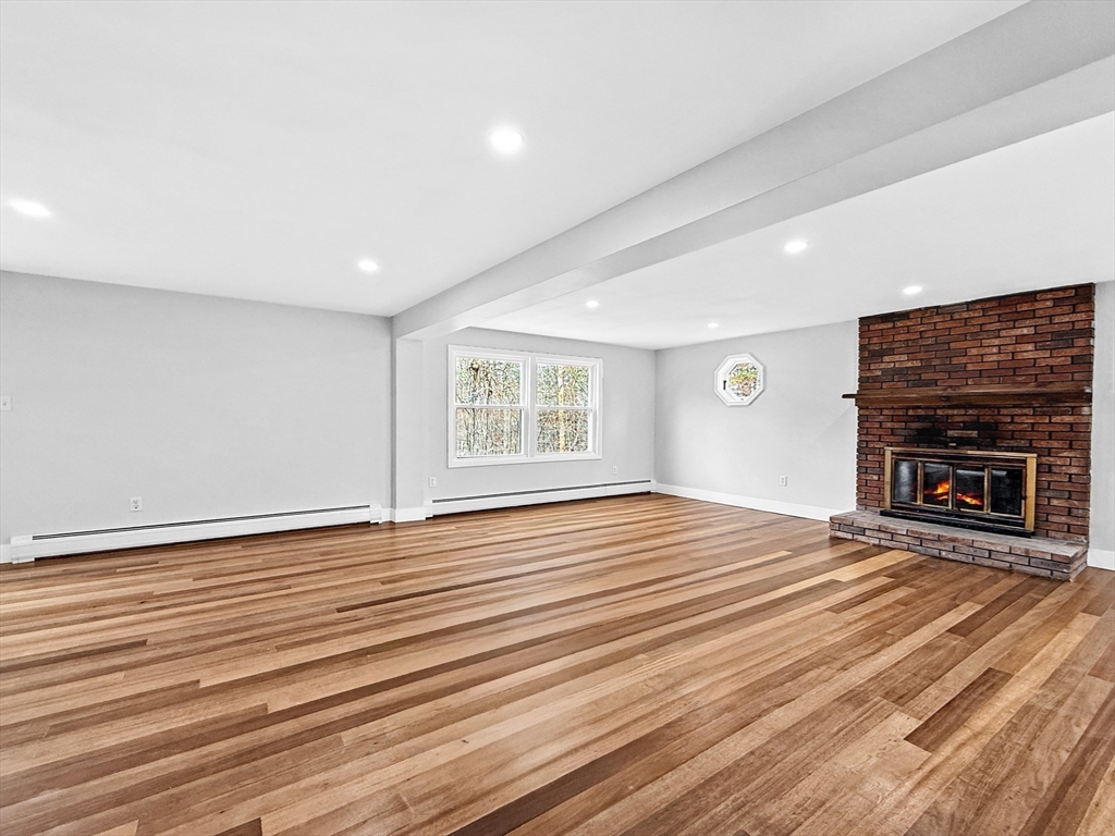 21 Burlington Road Billerica, MA 01821 - Photo 21 of 42 a view of an empty room with wooden floor fireplace and a window