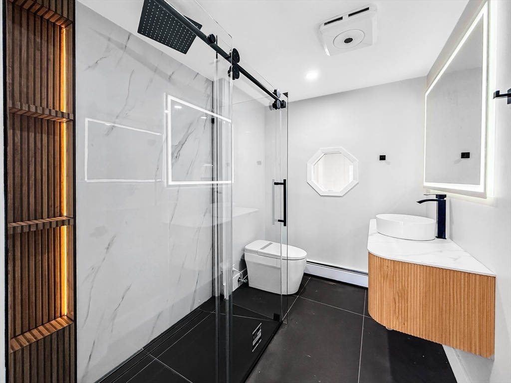 21 Burlington Road Billerica, MA 01821 - Photo 24 of 42 a bathroom with a toilet sink a mirror and shower