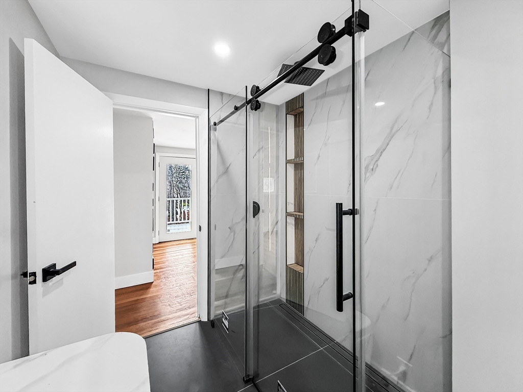 21 Burlington Road Billerica, MA 01821 - Photo 26 of 42 a bathroom with a shower and a glass door