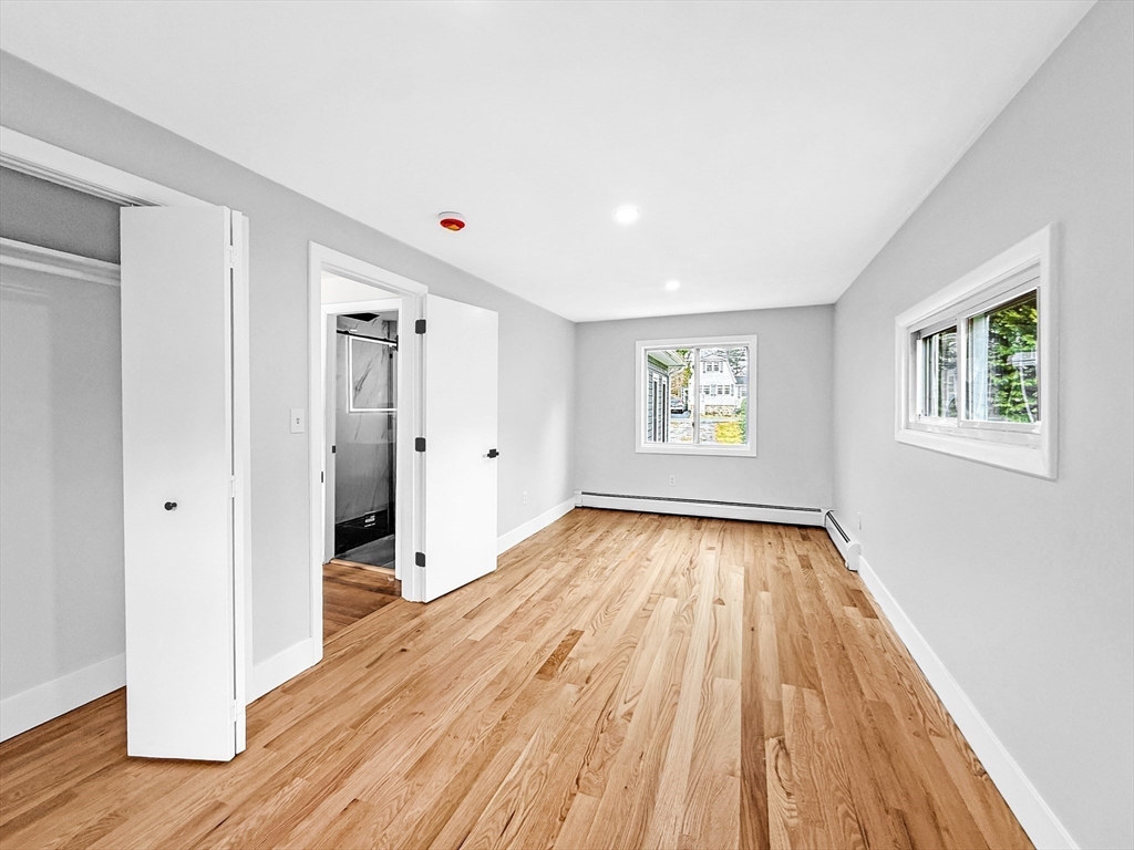 21 Burlington Road Billerica, MA 01821 - Photo 27 of 42 a view of an empty room with window and wooden floor