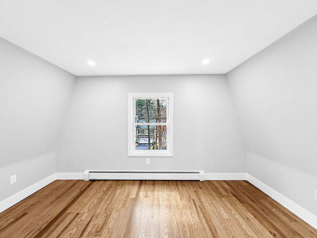 21 Burlington Road Billerica, MA 01821 - Photo 9 of 42 a view of an empty room with wooden floor and a window