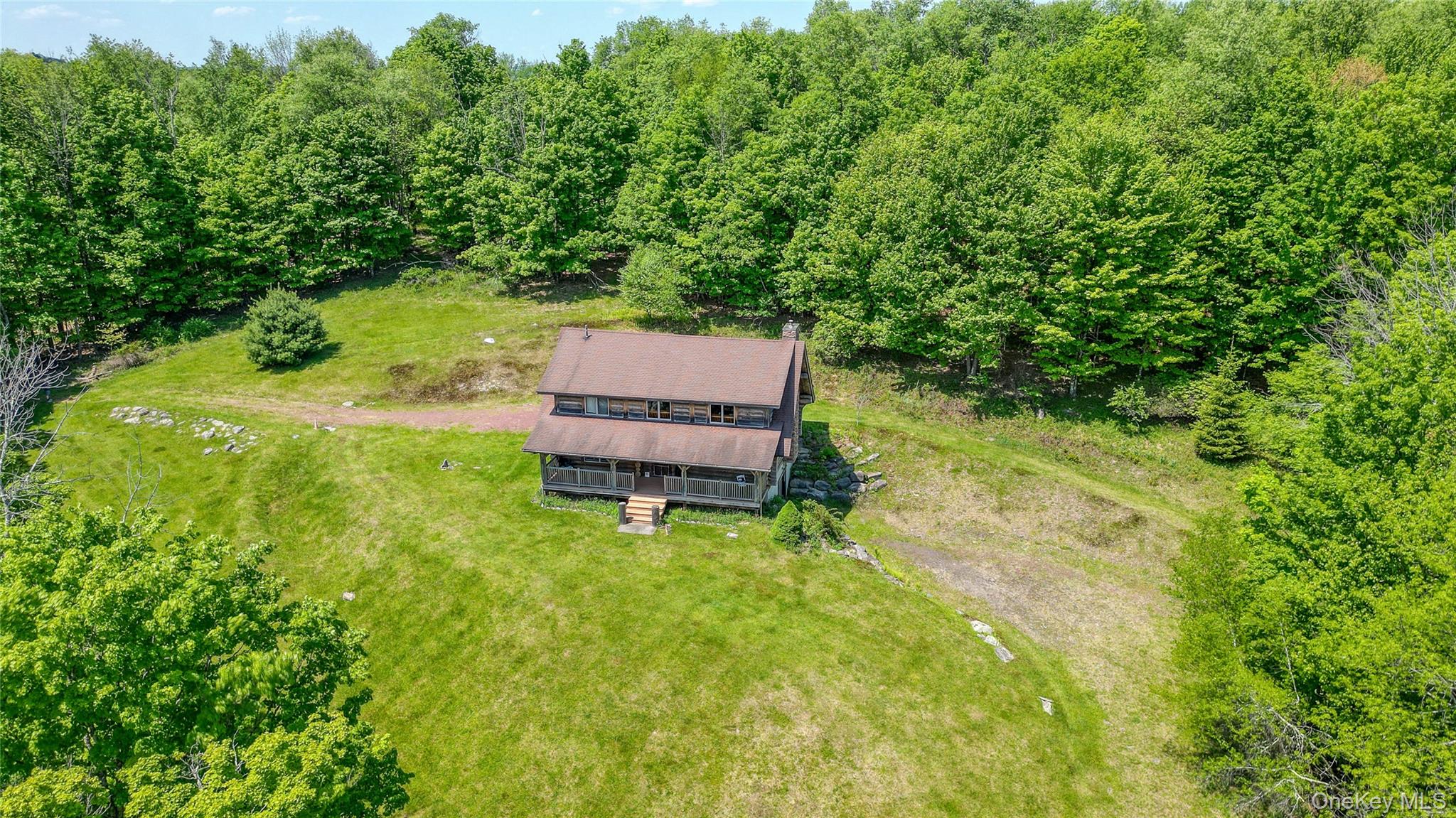25 Cauthers Road Fallsburg, NY 12789 - Photo 2 of 27 a backyard of a house with yard and outdoor seating