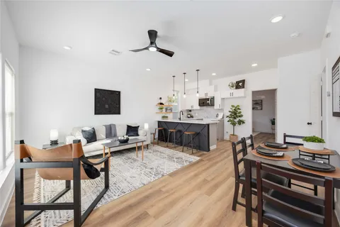 a living room with furniture and a wooden floor