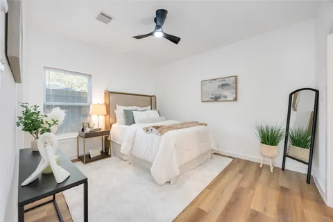 a bedroom with a bed and a potted plant