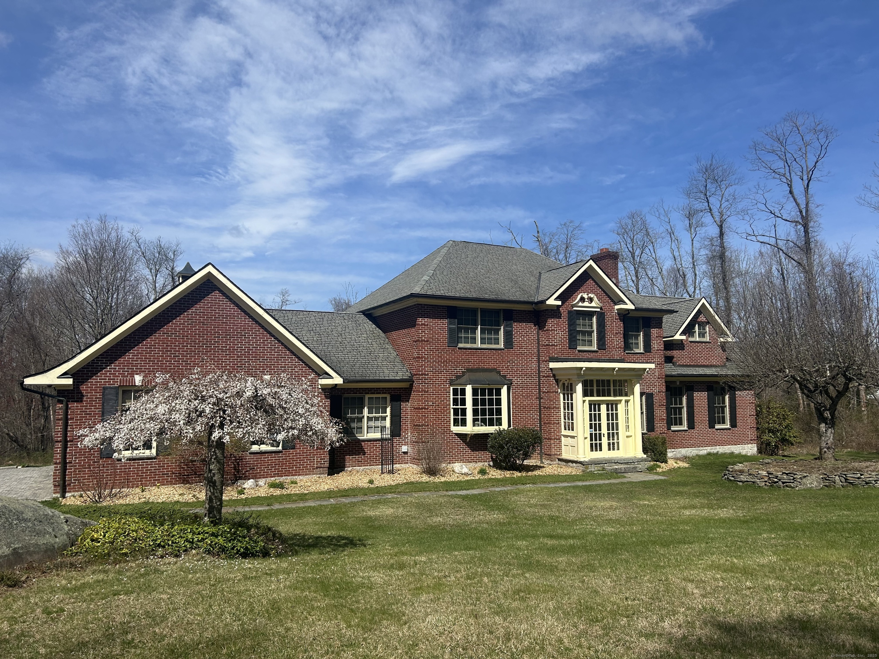 a front view of a house with a garden