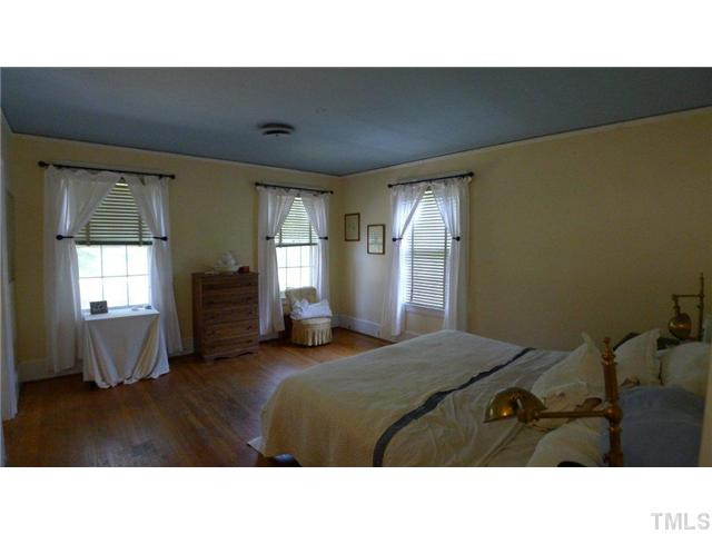 317 Dixie Trail, Unit 2 Raleigh, NC 27607 - Photo 19 of 25 a living room with a bed furniture and a window