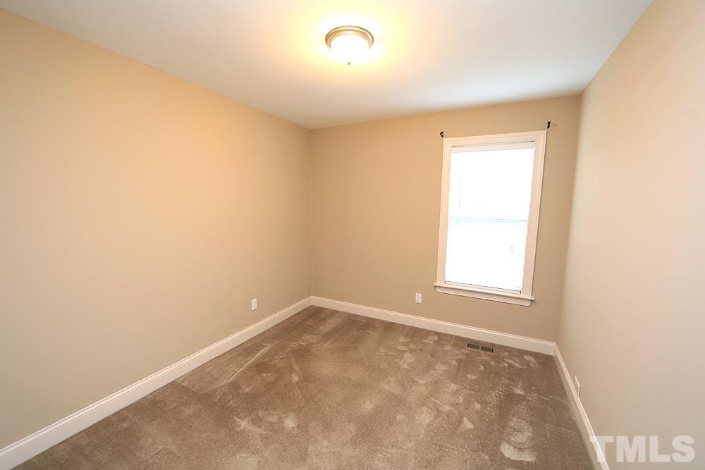 445 Chisenhall Road Angier, NC 27501 - Photo 8 of 12 an empty room with a window