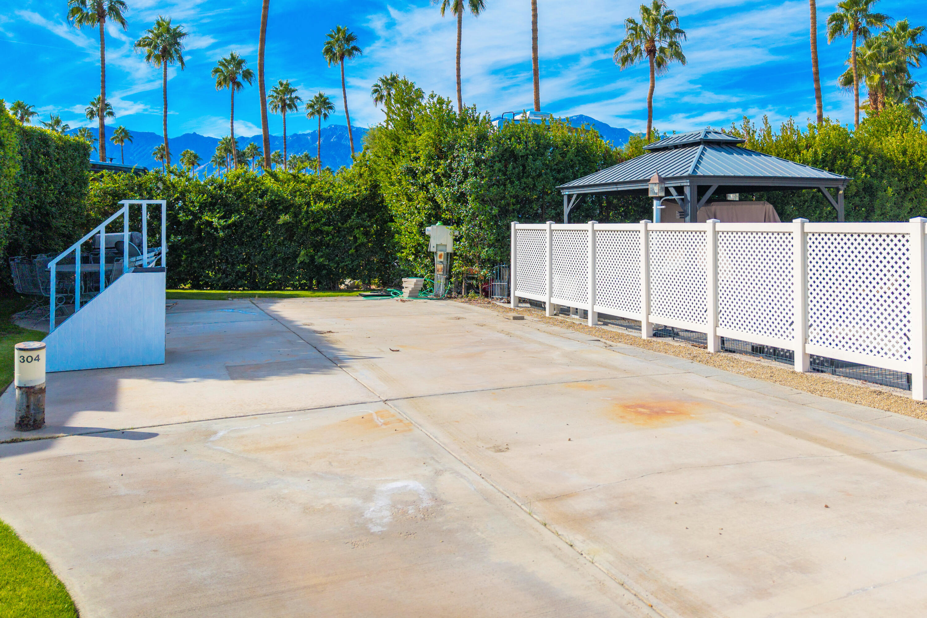 69411 Ramon Road, Unit 304 Cathedral City, CA 92234 - Photo 11 of 55 a front view of a house with a yard and trees