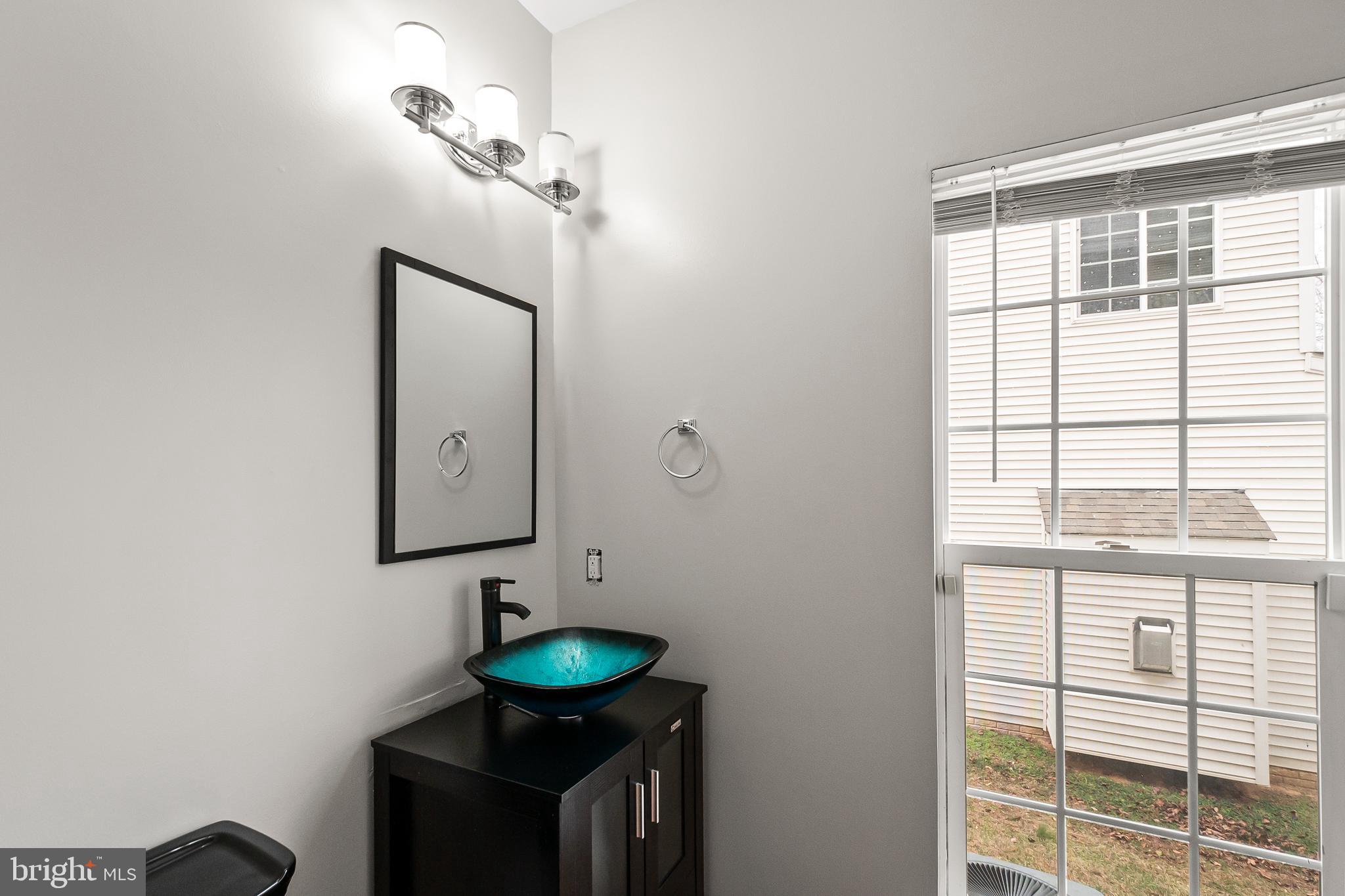 9015 Helmsley Drive Clinton, MD 20735 - Photo 20 of 53 a bathroom with a sink and a mirror