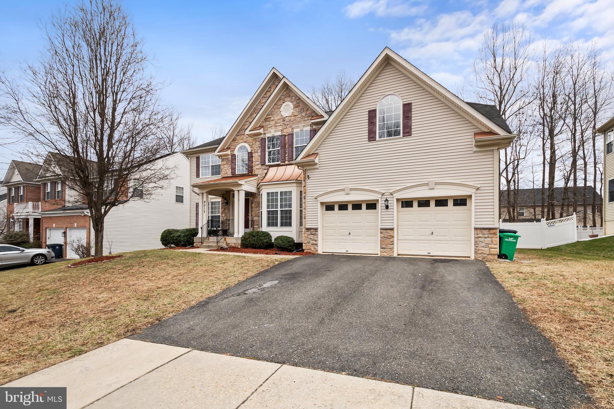 9015 Helmsley Drive Clinton, MD 20735 - Photo 2 of 53 a front view of a house with a yard and garage