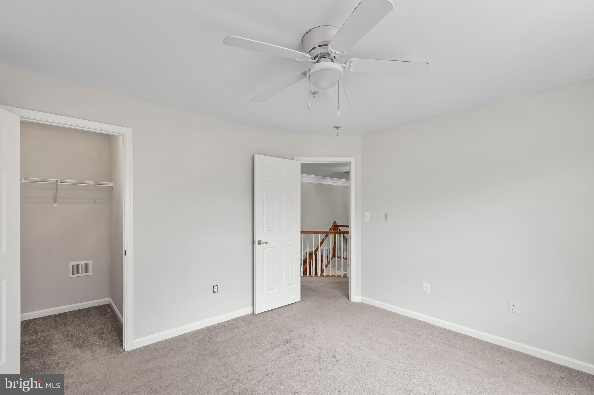 9015 Helmsley Drive Clinton, MD 20735 - Photo 22 of 53 an empty room with a ceiling fan and a bathroom