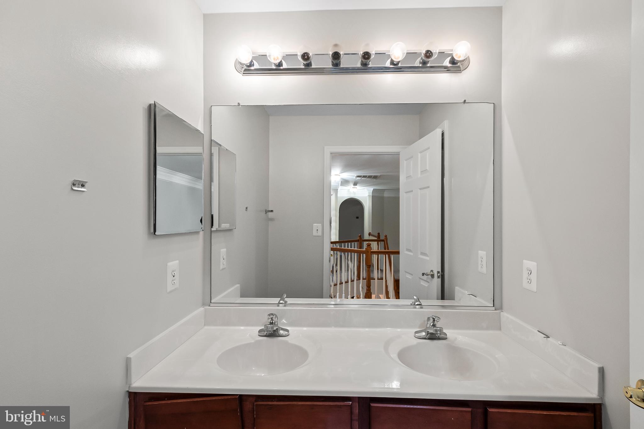 9015 Helmsley Drive Clinton, MD 20735 - Photo 23 of 53 a bathroom with a sink and a mirror
