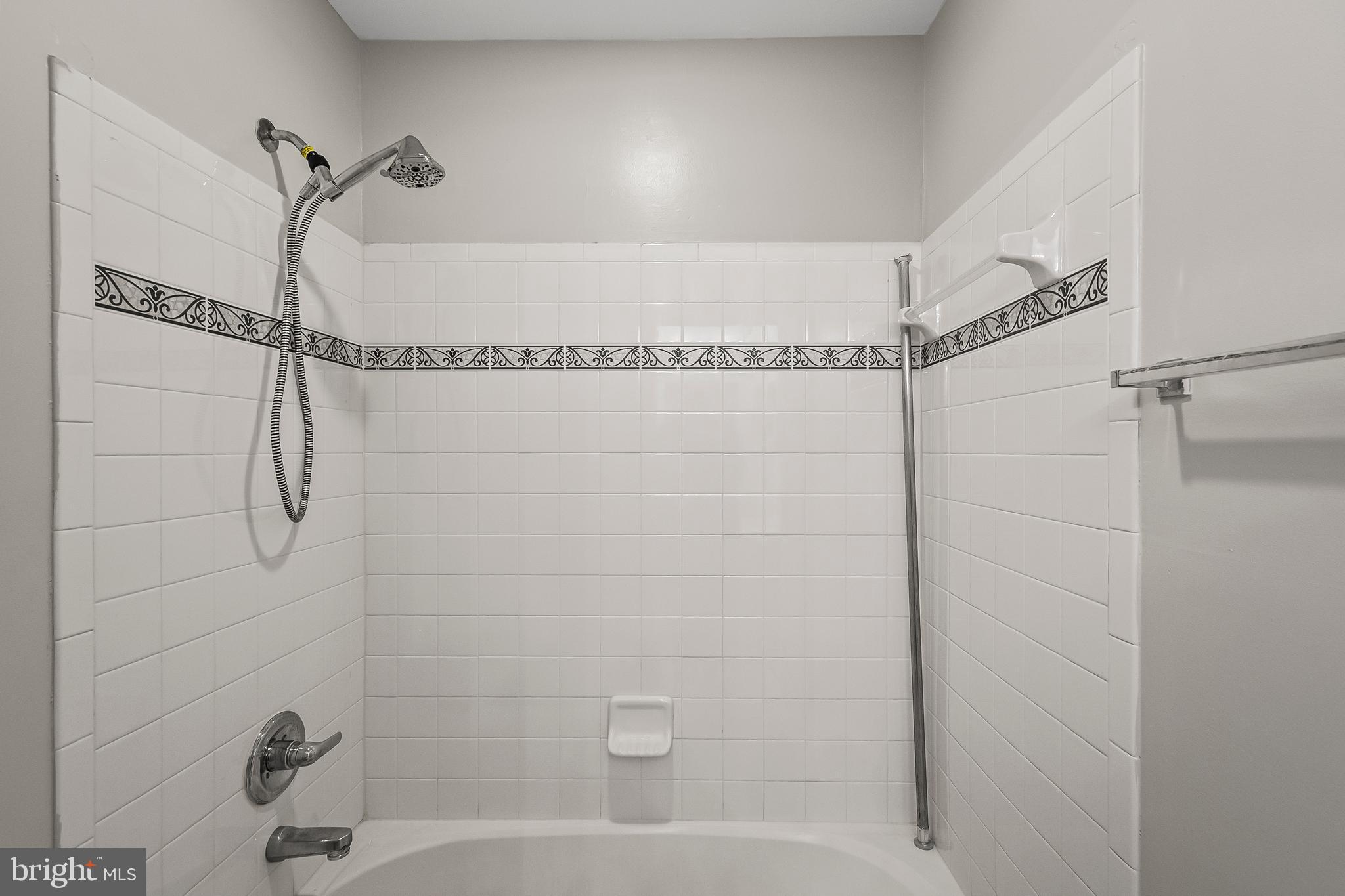 9015 Helmsley Drive Clinton, MD 20735 - Photo 29 of 53 a bathroom with a bathtub and a shower