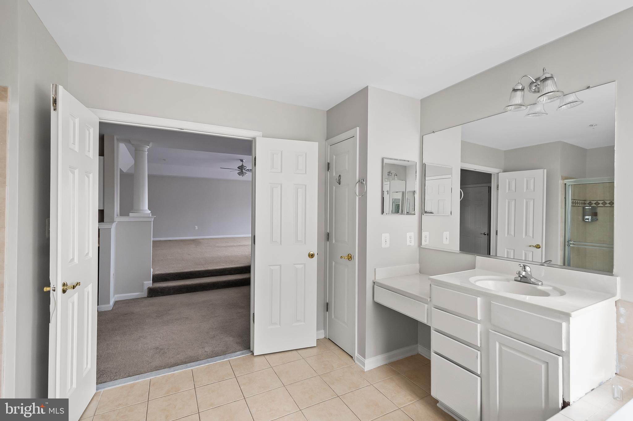 9015 Helmsley Drive Clinton, MD 20735 - Photo 37 of 53 a bathroom with a double vanity sink mirror and shower
