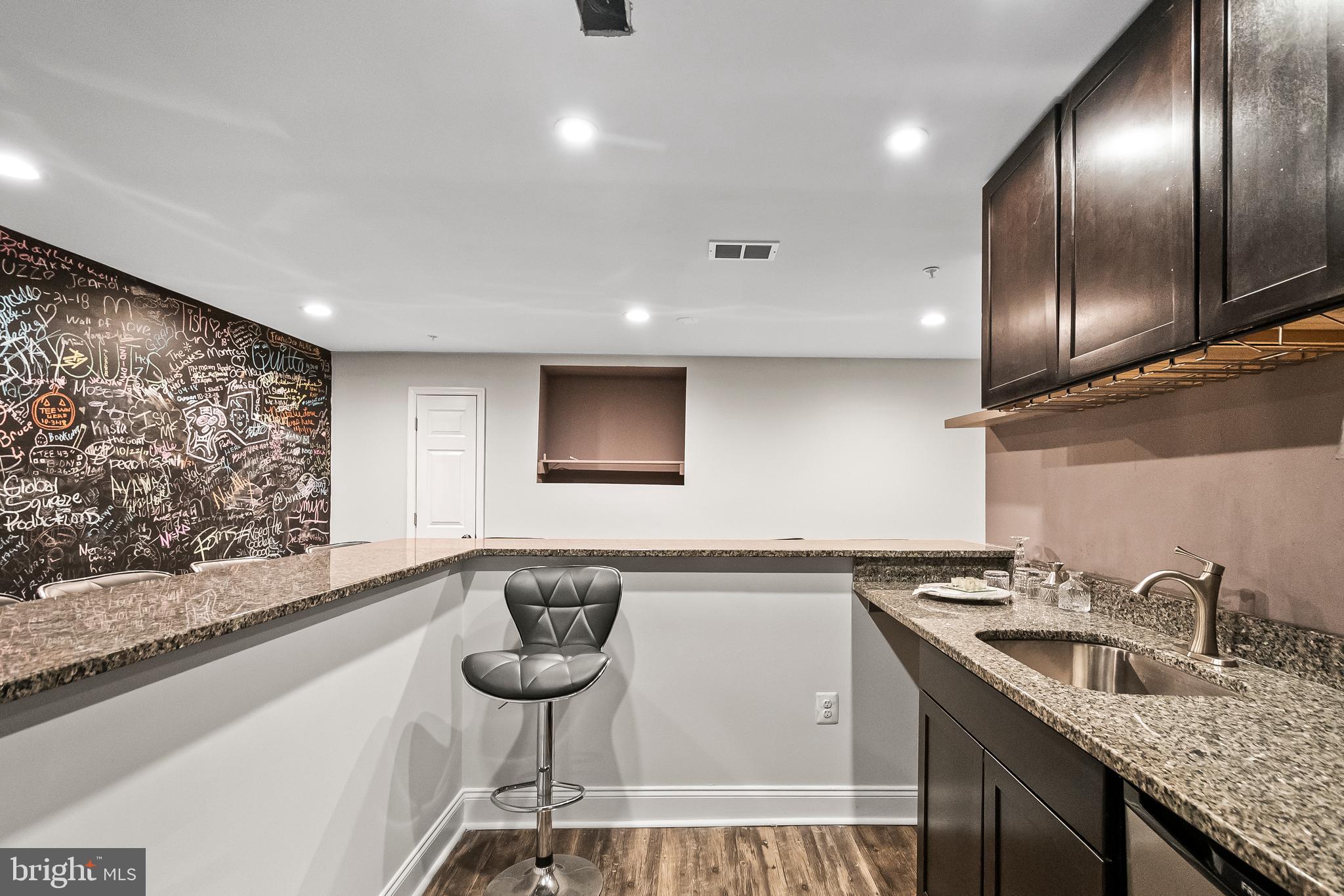 9015 Helmsley Drive Clinton, MD 20735 - Photo 41 of 53 a kitchen with granite countertop a sink and a wooden floor