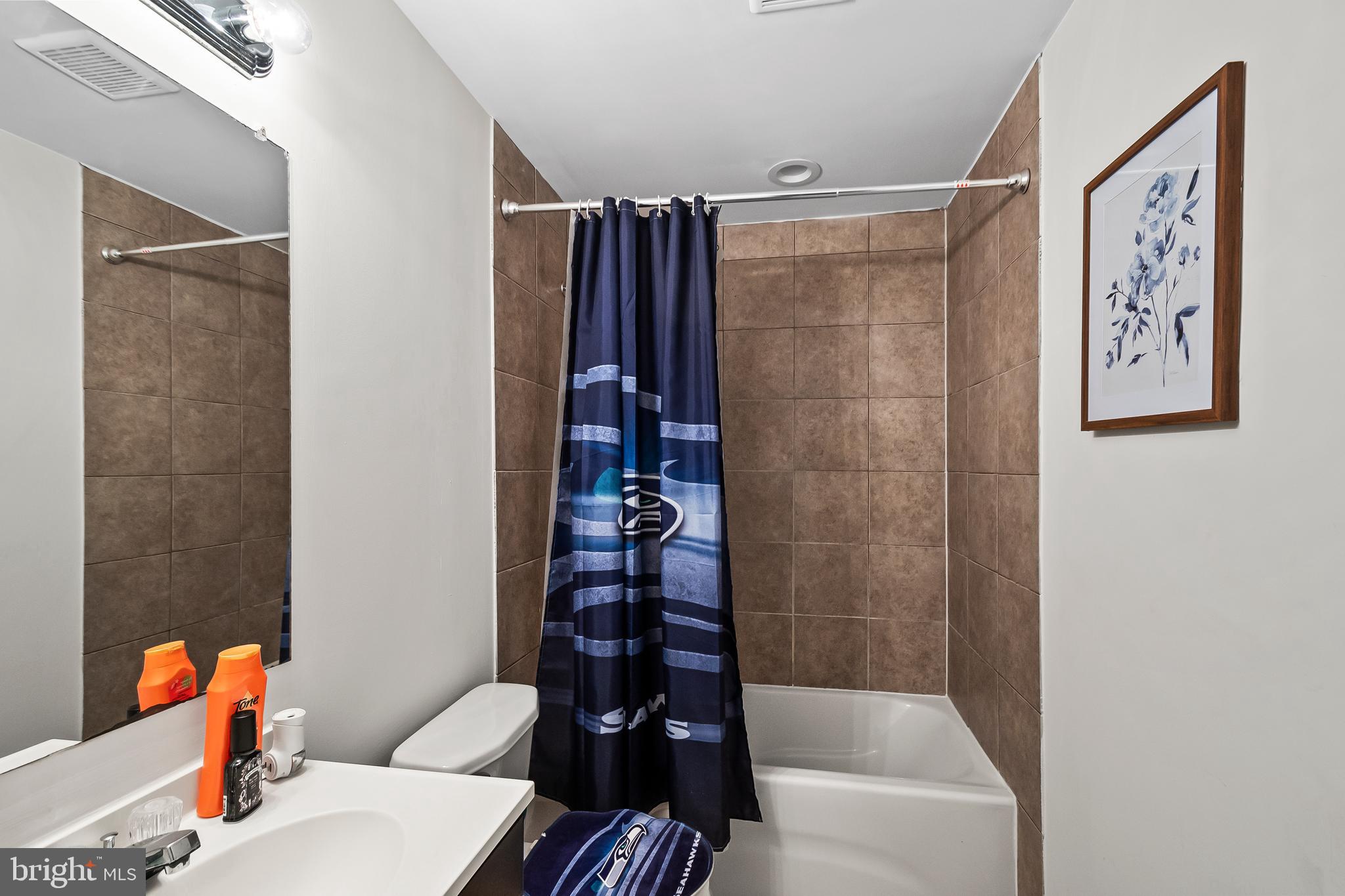 9015 Helmsley Drive Clinton, MD 20735 - Photo 44 of 53 a bathroom with a bathtub and a shower