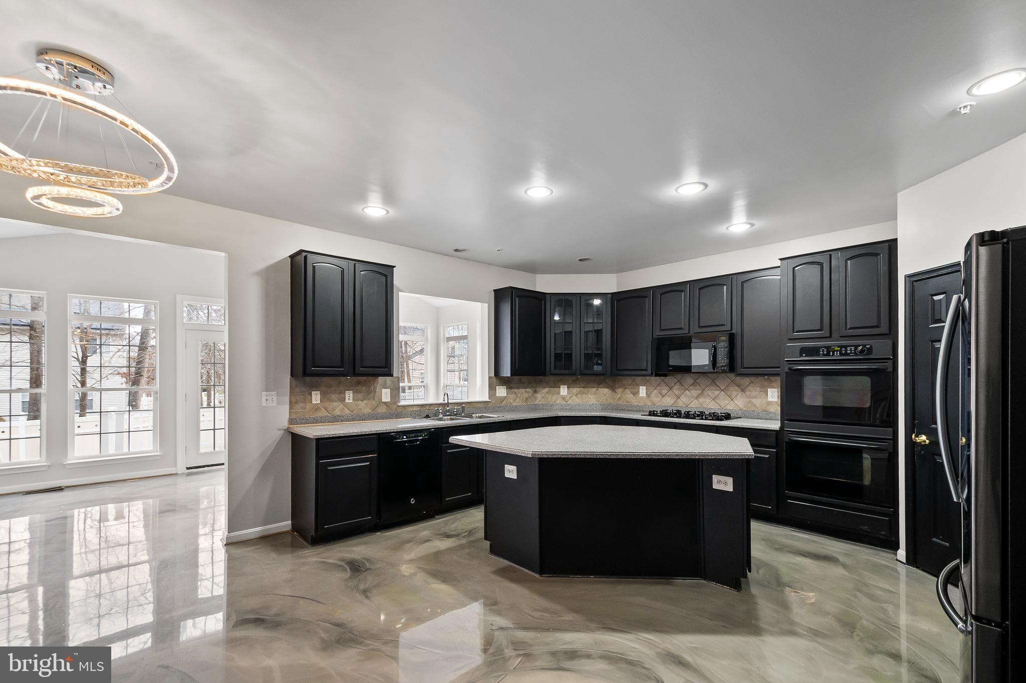 9015 Helmsley Drive Clinton, MD 20735 - Photo 8 of 53 a large kitchen with cabinets and stainless steel appliances