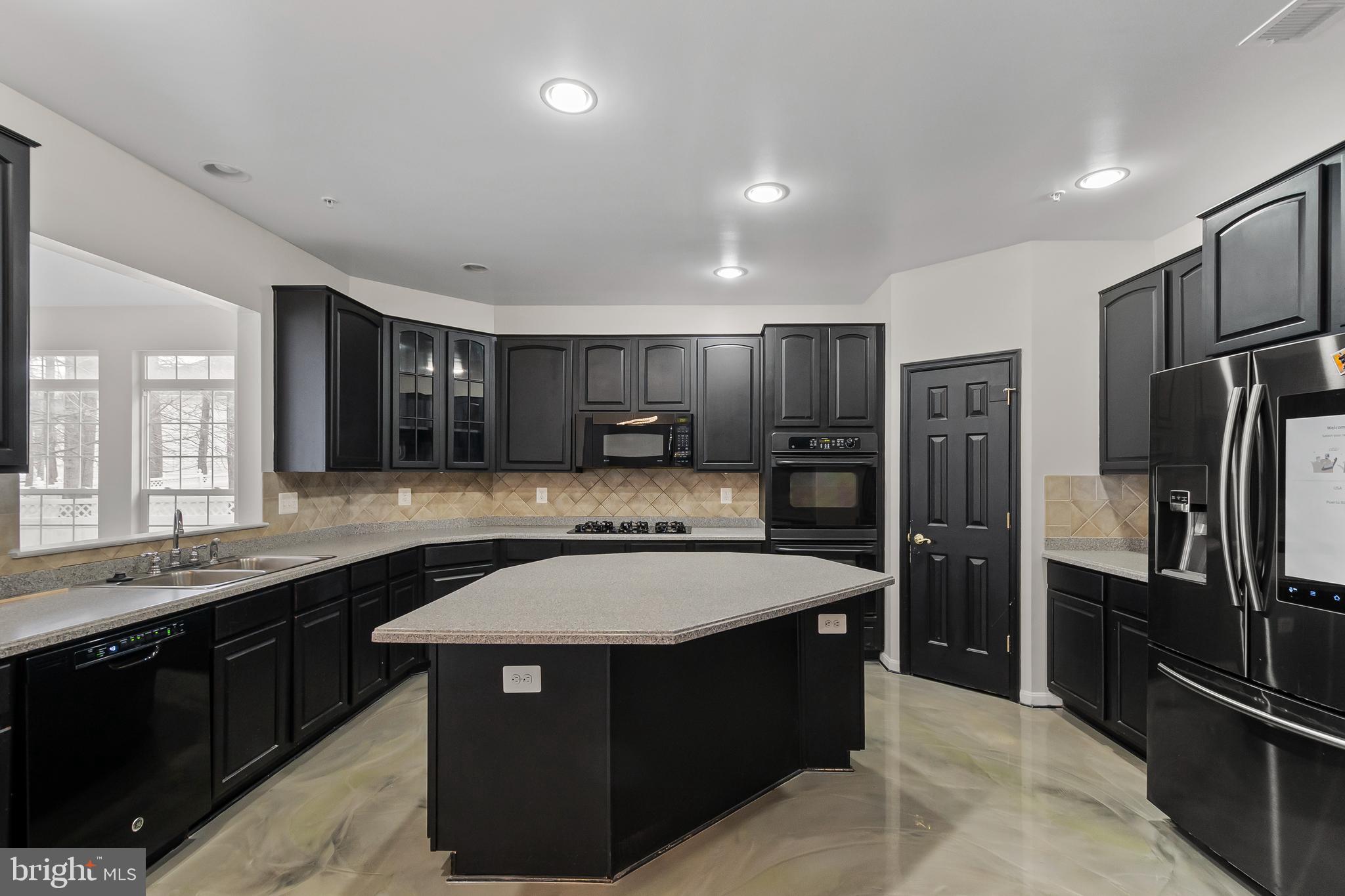 9015 Helmsley Drive Clinton, MD 20735 - Photo 9 of 53 a kitchen with stainless steel appliances granite countertop a sink stove and refrigerator