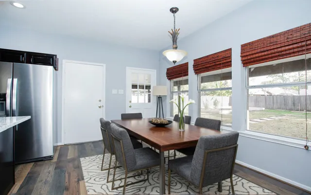 a view of a dining room with furniture window and wooden floor