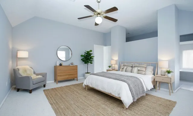 a bedroom with a bed and a chandelier