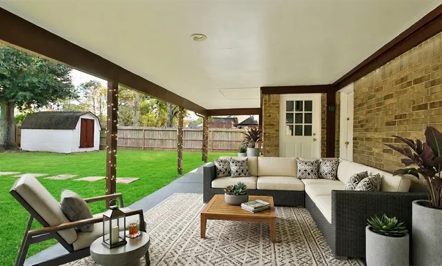 a living room with furniture and a garden