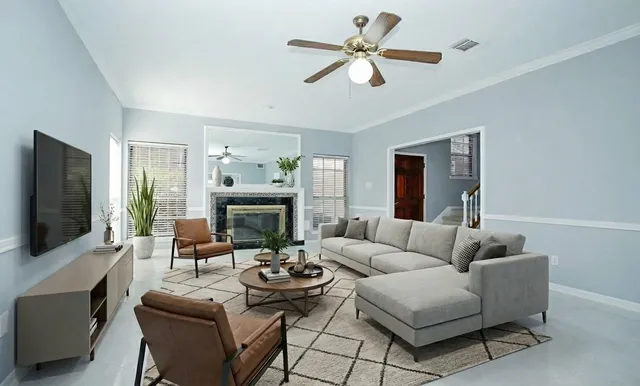 a living room with furniture a fireplace and a flat screen tv