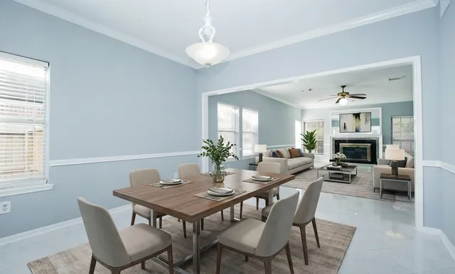 a view of a dining room with furniture and a potted plant