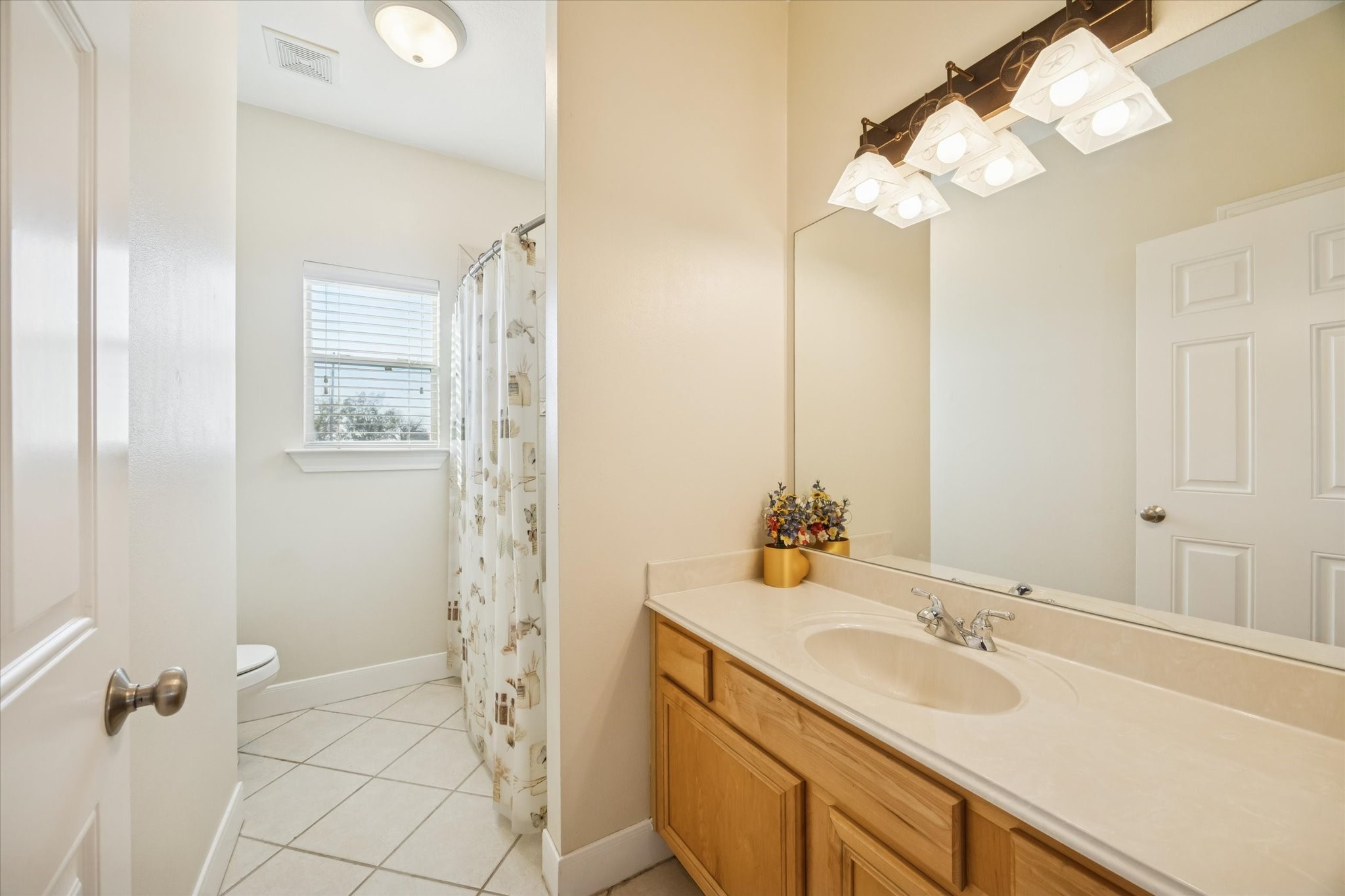 32410 Phlying Road Waller, TX 77484 - Photo 14 of 26 a bathroom with a double vanity sink a mirror and a shower