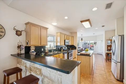 a spacious bedroom with a bed and a chandelier