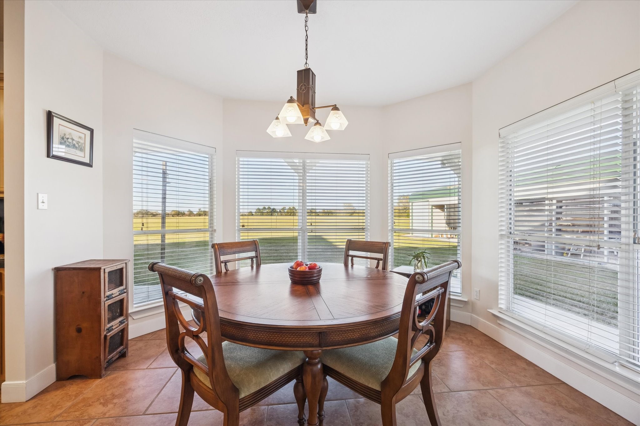 32410 Phlying Road Waller, TX 77484 - Photo 10 of 26 a dining room with furniture a chandelier and wooden floor